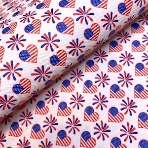 May include: White fabric with a repeating pattern of red, white, and blue hearts and fireworks. The hearts are striped with red and blue stripes and the fireworks are blue and red.