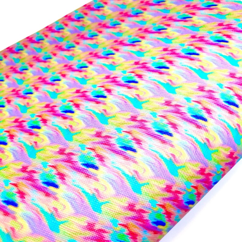 May include: A colorful fabric with a repeating pattern of blue, pink, yellow, and green swirls. The fabric has a slightly textured surface.