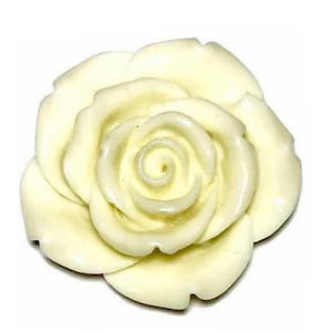 May include: A cream-colored rose, with multiple layers of petals, is the focal point of this image. The rose is a three-dimensional object, with a detailed spiral center. The petals have a smooth, glossy finish, and the overall shape is round.