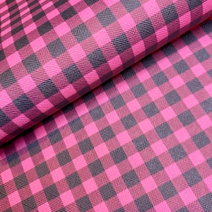 May include: Pink and black checkered fabric with a textured surface.