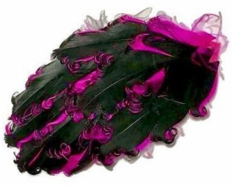 May include: A decorative feather fan in a curved shape. The fan features black feathers with vibrant magenta accents and curled details. The fan is set against a white background.