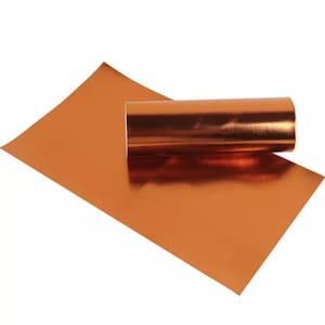May include: A roll of copper metallic vinyl sheet. The sheet is rolled up and the end is laying flat on a white surface.