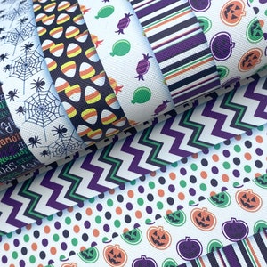 May include: A collection of Halloween-themed fabric strips with various patterns. Designs include spiderwebs, candy corn, stripes, candy, jack-o'-lanterns, and polka dots in colors like black, orange, purple, and green. The fabric has a textured appearance.