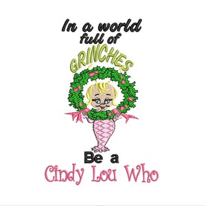 May include: A green wreath with red berries and a cartoon girl holding it. The text reads "In a world full of Grinches Be a Cindy Lou Who".