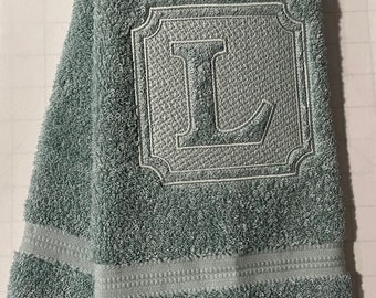 Embossed monogram hand towel.