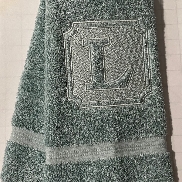 Embossed monogram hand towel.