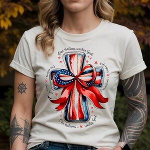 One Nation Under God T-Shirt - Christian American Flag Cross Tee with Patriotic Bow - Faith Based Religious Shirt - 4th of July Gift USA