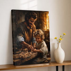 May include: A canvas print depicts a man and a child working together at a wooden workbench. The man, with a beard, smiles as he guides the child. The scene is illuminated by warm light, suggesting a workshop setting. A white vase with yellow flowers sits on a wooden shelf.