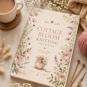 May include: A rectangular knitting journal with a cream-coloured cover featuring floral illustrations, a yarn ball, and the text COTTAGE BLOOM KNITTING JOURNAL A PROJECT JOURNAL FOR KNITTERS 10 PROJECTS NOTES MEMORIES printed in brown and pink.