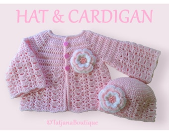May include: A light pink crochet cardigan and matching hat set. The set features a floral design with white and pink accents and pearl-like beads. The cardigan has three pink buttons and the text "HAT & CARDIGAN".