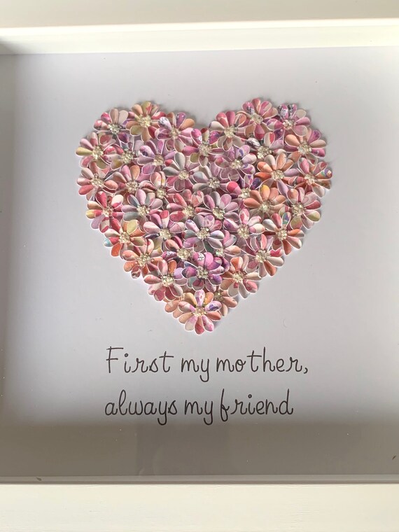 A bespoke heart made with small, delicate, handmade flowers with the words First my mother always my friends underneath