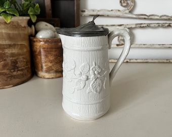 Small antique white relief pitcher with floral design and pewter lid - salt glazed ironstone syrup jug