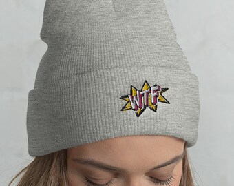 May include: A gray beanie with a yellow and red "WTF" graphic on the front.