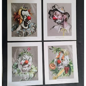 May include: Four vintage clown prints. Each print features a different clown portrait with a unique expression and costume. The clowns have red noses and are set against a neutral background. The prints are labeled with the clown's name.