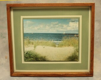 A 11 x 14 in photograph of Lake Michigan beautiful Ludington's North Pierhead Light is creatively float mounted in a 17 1/2" x 20"  frame.