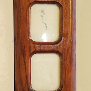 A multiple opening, two 4&quot; x 5&quot;-6&quot; sold wood photo frame crafted to hang portrait or landscape. This frame has especially natural finish.