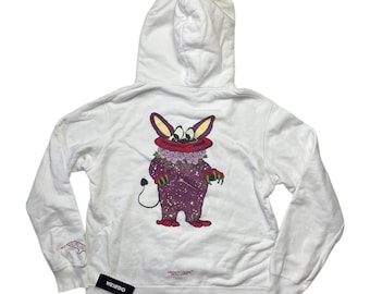May include: White hooded sweatshirt with a graphic print of a purple creature with a red mouth and a flower crown on the back. The text "WEIRDO" is printed on the bottom left of the sweatshirt.