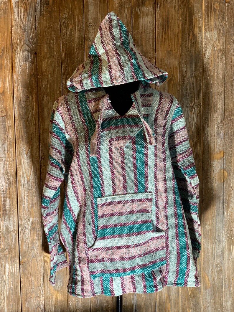 May include: A hooded striped poncho with a green, pink, and white color scheme. The poncho has a single pocket on the front.