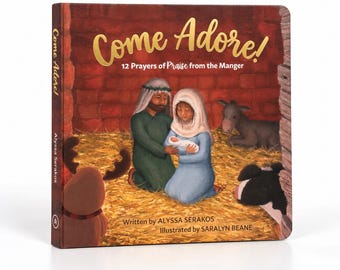 May include: A hardcover book titled Come Adore! 12 Prayers of Praise from the Manger, written by Alyssa Serakos and illustrated by Saralyn Beane. The cover features a painted illustration of a family in a stable with a donkey and a cow.