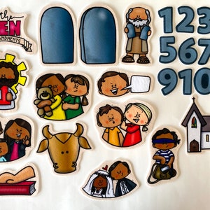 May include: A collection of illustrated cutouts depicting religious themes. Includes the text "The Ten Commandments", two blue tablets, numbers 1-10, and various figures and scenes, such as a church and people.