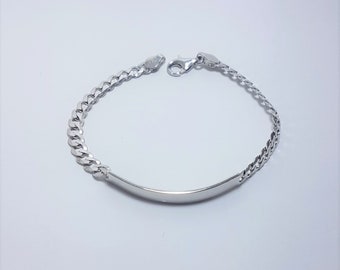 May include: A polished silver ID bracelet featuring a smooth, curved rectangular identification plate connected to a classic curb chain. The bracelet is secured with a lobster claw clasp and includes a small metal tag near the closure mechanism.