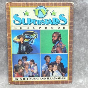 May include: A vintage book cover with the title "TV Superstars Scrapbook" featuring a collage of four images. The top left image shows a man in a black leather jacket driving a silver car. The top right image shows a man with a beard and a black headband. The bottom left image shows a group of people, including a woman with blonde hair. The bottom right image shows a group of people, including a man in a suit.