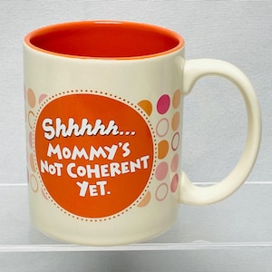 May include: A set of three ceramic mugs with a speckled, matte finish. The mugs are in shades of cream, light gray, and dark gray. Each mug has a simple, minimalist design and a rounded handle.