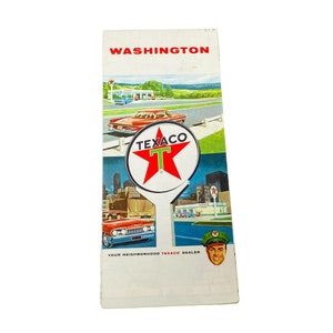 May include: A vintage Texaco gas station map for Washington, D.C. The map features a red star with a white "T" in the center, a red car, and a Texaco gas station attendant wearing a green hat.