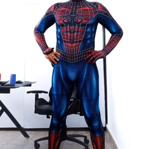 May include: A full-body Spider-Man costume in blue, red, and black. The suit features a web pattern across the red areas and a spider emblem on the chest. The mask covers the entire head, with white eye lenses.