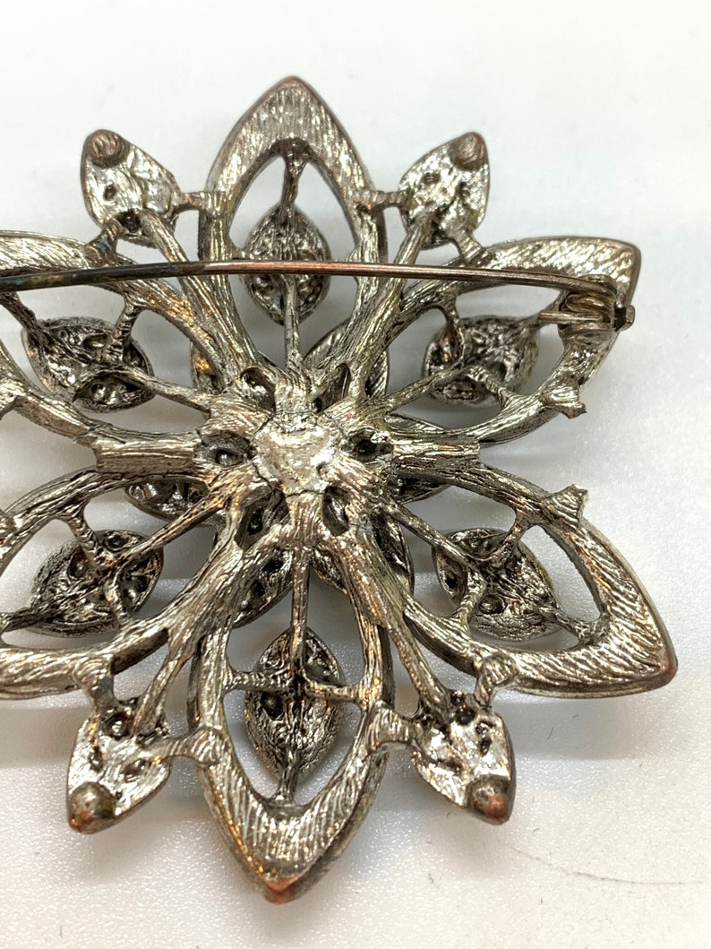 Vintage silver tone and cut iridescent black glass and black rhinestone floral brooch