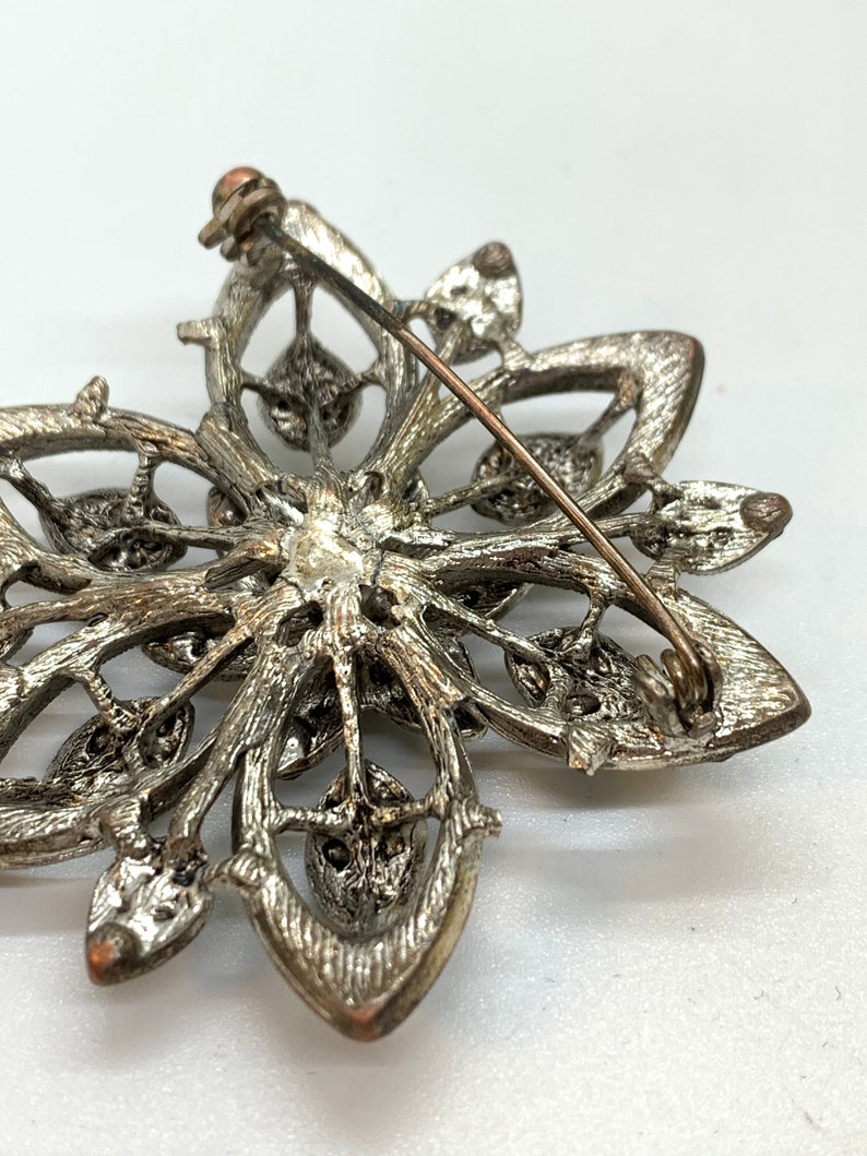 Vintage silver tone and cut iridescent black glass and black rhinestone floral brooch
