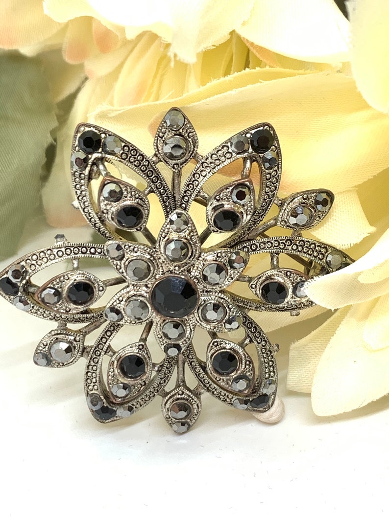 Vintage silver tone and cut iridescent black glass and black rhinestone floral brooch