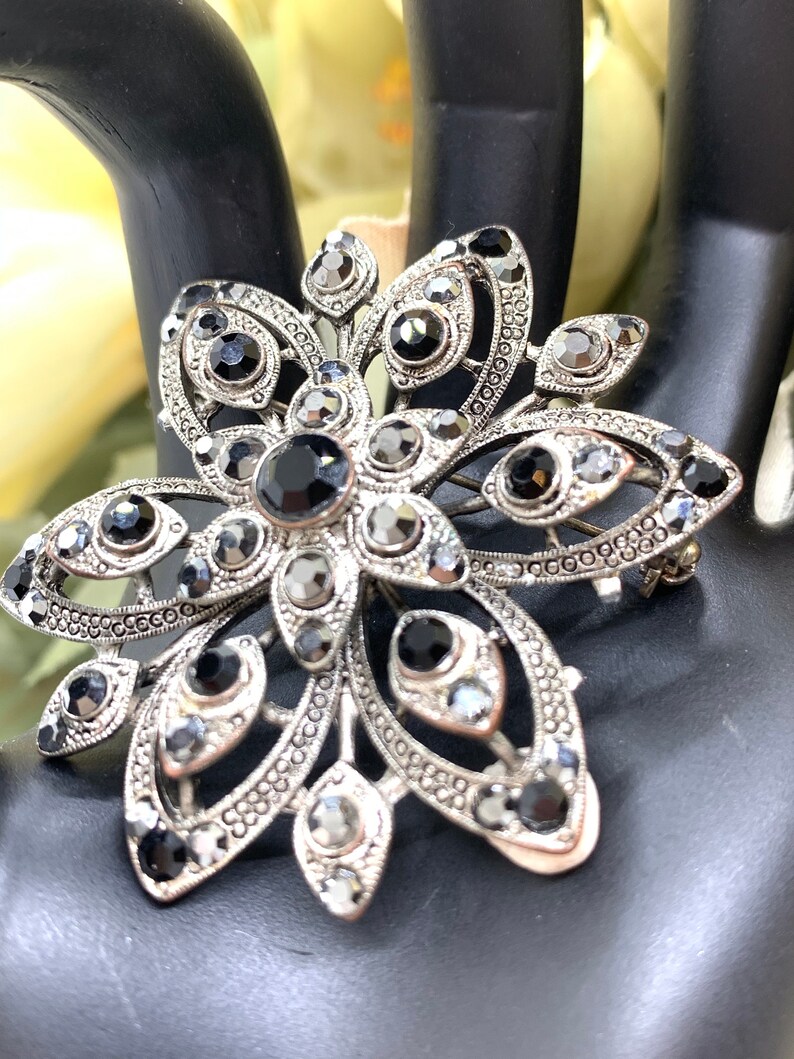 Vintage silver tone and cut iridescent black glass and black rhinestone floral brooch