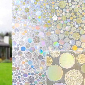 May include: Decorative window film with a pattern of iridescent, textured circles in various sizes. The film has a gradient effect, transitioning from clear to a mix of colors including yellow, blue, and pink. The film is shown in front of a house.