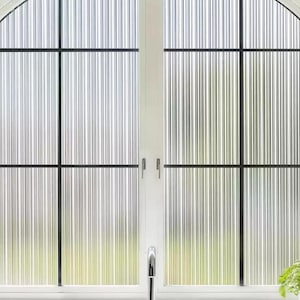 May include: A white arched window with a black grid pattern. The window has a textured, vertical striped design. Green plants in white vases and pots are visible in the foreground.