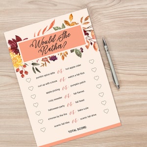 May include: A Would She Rather game sheet with fall-themed graphics and text. The sheet features a peach background with floral accents and a pen. The game includes options like pumpkin spice latte or hot apple cider.
