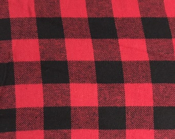 May include: Red and black plaid fabric with a woven texture.