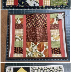 May include: A set of three quilted placemats. The first features a patchwork design with red stripes and camping-themed fabric. The second has a mix of patterns with brown, orange, and green hues. The third has yellow triangles and a floral pattern.