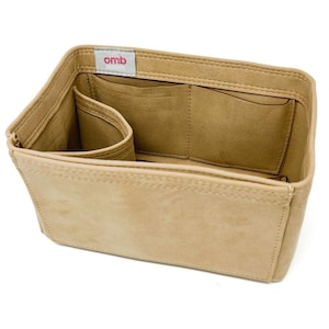 May include: Beige felt bag organizer with multiple compartments and a small pocket labeled "omb".