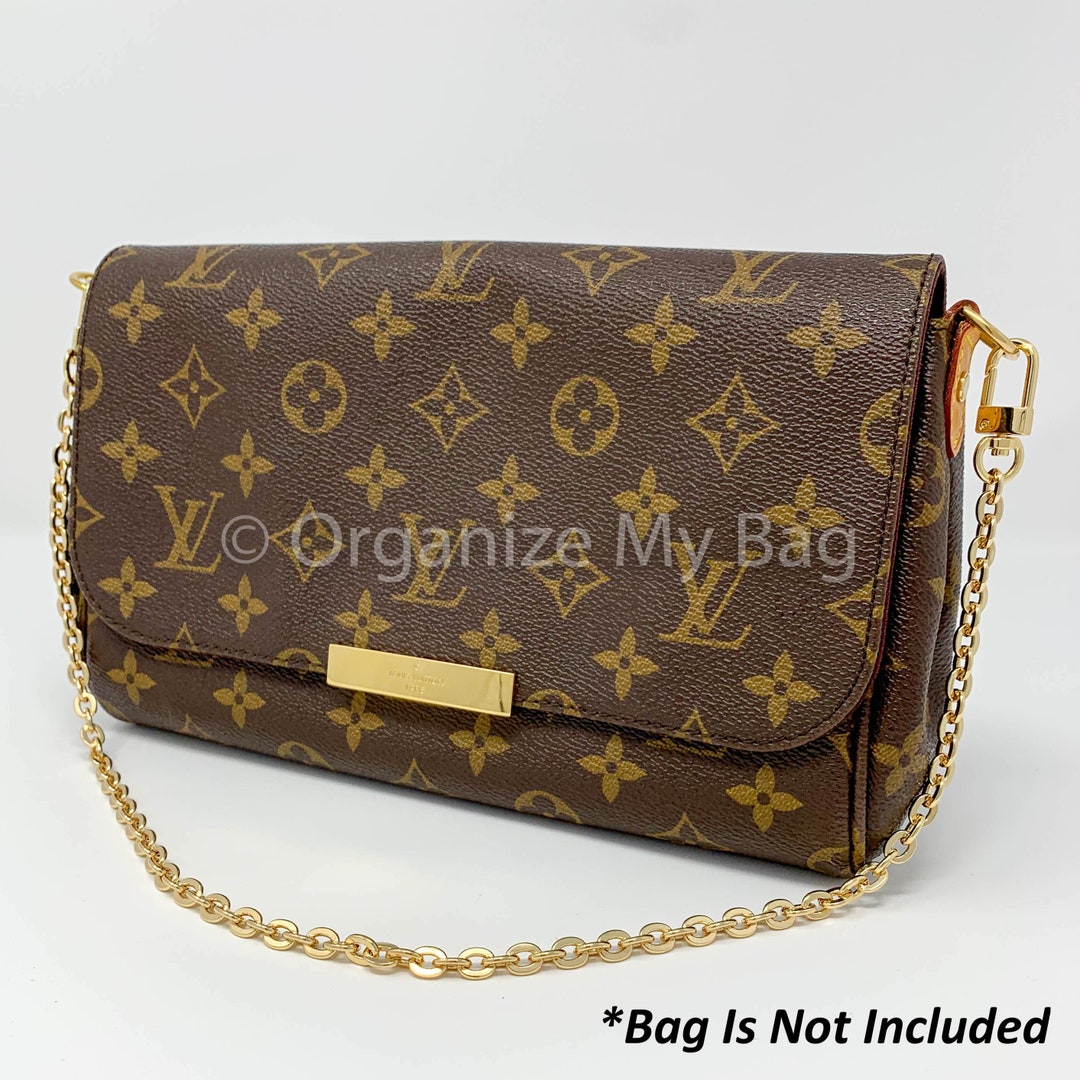Premium AI Image  a black and gold purse with a gold chain on the front