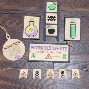 May include: Wooden Halloween decorations with a potion testing site sign, a witches brew recipe, a test tube, a cauldron, and a skull and crossbones banner.