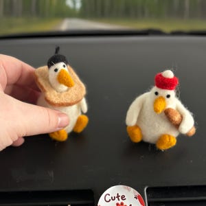 May include: Handmade felted bird figurines, one with a black hat and toast collar, the other with a red hat and a brown item. Two round stickers with the text "Cute Paw Shop" and a paw print.