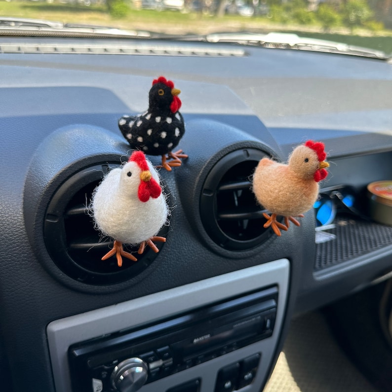 May include: Three felt chicken car air fresheners. One is black and white with red accents, one is white with red accents, and one is brown with red accents.