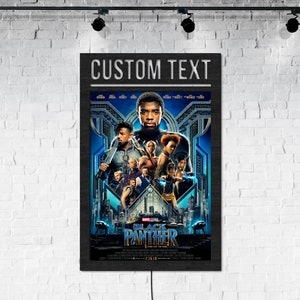 May include: Black Panther movie poster with the text "CUSTOM TEXT" at the top. The poster features a group of characters from the movie, including Black Panther, Okoye, and Nakia. The poster is set against a backdrop of the city of Wakanda.
