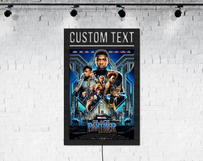 May include: Black Panther movie poster with the text "CUSTOM TEXT" at the top. The poster features a group of characters from the movie, including Black Panther, Okoye, and Nakia. The poster is set against a backdrop of the city of Wakanda.