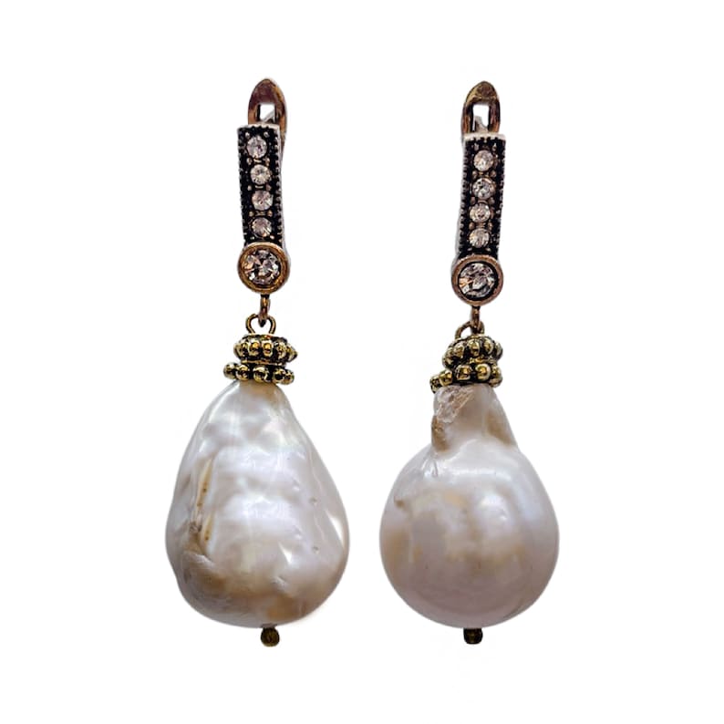 May include: A pair of silver earrings with a baroque pearl drop and a crystal-encrusted bar. The pearls are white and the crystals are clear.