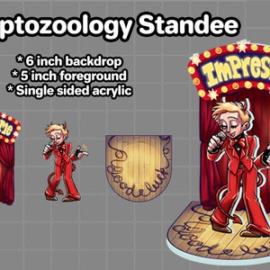 May include: A 6-inch tall acrylic stand-up cutout of a cartoon character with red hair and a devil tail, holding a microphone and standing on a stage with a red curtain and a sign that says "Impress Me".