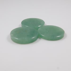 May include: Three round, polished, light green aventurine stones are arranged on a white surface. The stones have a smooth, flat surface and a slightly translucent appearance. The stones are a natural product.