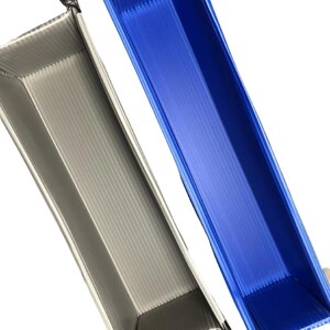May include: Two plastic trays, one gray and one blue, with a corrugated texture. The trays are folded and have a handle on each end.