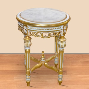 May include: A small, ornate side table with a round, marble-like top. The table features gold-painted accents and light blue detailing. The legs are intricately carved, and the table has a height of approximately 24 inches.